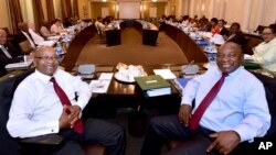 In this photo supplied by the South African Government Communications and Information Services (GCIS) South African President Jacob Zuma, left, and Deputy President Cyril Ramaphosa, right, with minsters and deputy ministers at a scheduled routine meeting.