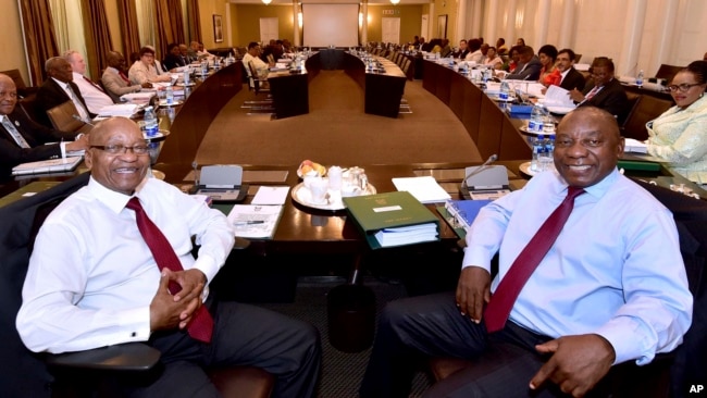 In this photo supplied by the South African Government Communications and Information Services (GCIS) South African President Jacob Zuma, left, and Deputy President Cyril Ramaphosa, right, with minsters and deputy ministers at a scheduled routine meeting.