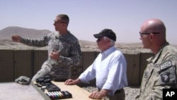 Secretary Gates receives a briefing from officers at Combat Outpost Senjaray, Afghanistan