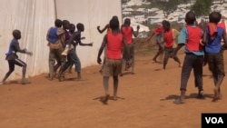 Children pass the time by playing intense soccer matches between the tents.