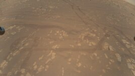 This is the first color image of the Martian surface taken by an aerial vehicle while it was aloft. The Ingenuity Mars Helicopter captured it with its color camera during its second successful flight test on April 22, 2021. (NASA/JPL-Caltech)