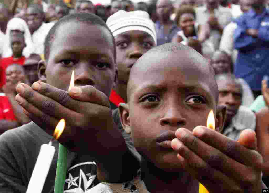August 10: Children hold candles during a rally by Uganda's opposition parties in memory of the nine people who died during a government crackdown on protesters taking part in the "walk to work" campaign in Masaka town. The campaign called on Ugandans to 