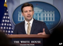 FILE - White House press secretary Josh Earnest speaks during the daily news briefing at the White House in Washington.