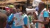 FILE - Health workers teach people about the Ebola virus and how to prevent infection in Conakry, Guinea, March 31, 2014. 