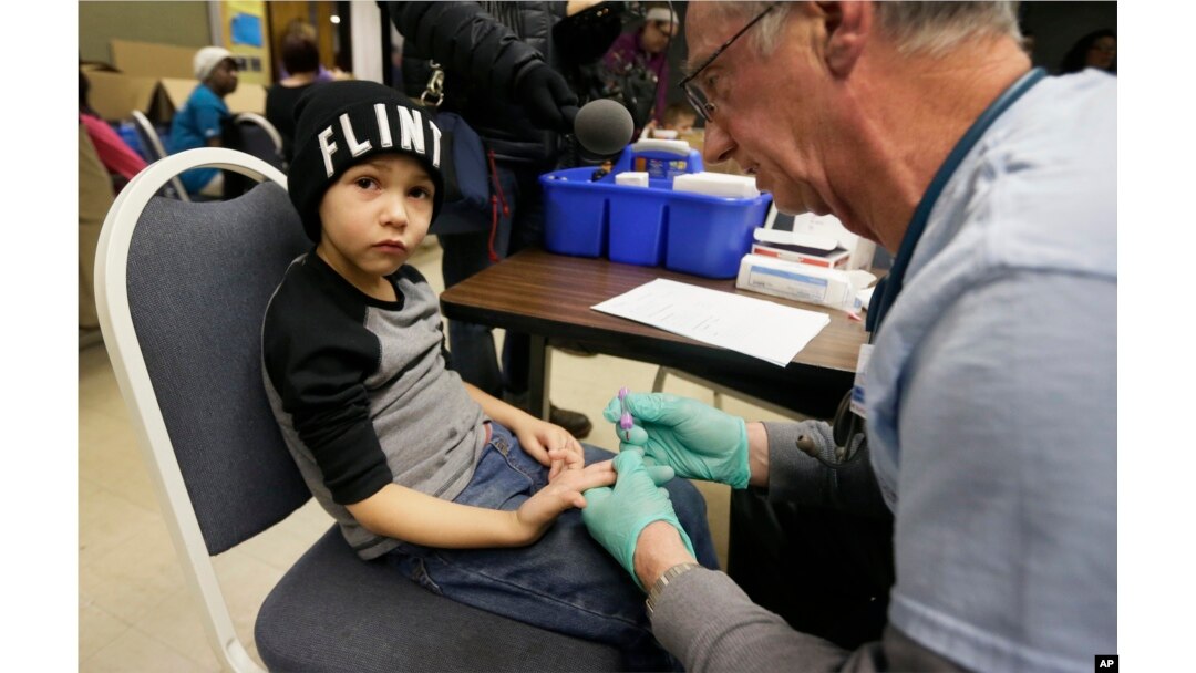 A nurse draws a blood sample from a student at Eisenhower Elementary School in Flint, Michigan, Jan. 26, 2016. Students at the school were being tested for lead after the metal was found in the city's drinking water.