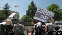 Pro-Islamic Turks, in support of ousted Egyptian President Mohammed Morsi shout slogans including "This is the home of the murderers" as they point toward the U.S embassy during a protest in Ankara, July 5, 2013.