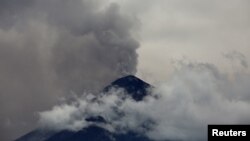 The Fuego volcano spews a cloud of steam and ash high into the air, as seen from Antigua, Guatemala, May 5, 2017.