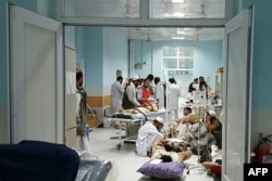 In this undated photograph released by Doctors Without Borders (MSF) on October 3, 2015, Afghan MSF medical personnel treat civilians injured following an offensive against Taliban militants by Afghan and coalition forces at the MSF hospital in Kunduz.