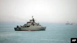 FILE - In this picture taken April 7, 2015, and released by the semiofficial Fars News Agency, the Iranian warship Alborz, foreground, in seen in the Strait of Hormuz.