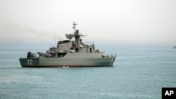 FILE - In this picture taken April 7, 2015, and released by the semiofficial Fars News Agency, the Iranian warship Alborz, foreground, prepares before leaving Iran's waters, at the Strait of Hormuz. Located on the eastern edge of the Persian Gulf, the Strait of Hormuz is one of the world's most important export routes.