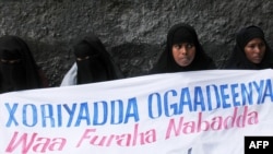 FILE - Ogaden National Liberation Front activists hold a banner in Mogadishu that reads, "The Ogaden freedom is the key to peace in the Horn of Africa," during a ceremony that marked the organization's 22nd anniversary in Somalia, Aug. 15, 2006.