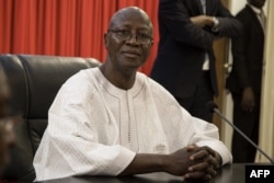 FILE - Burkina Faso's then-Prime Minister Christophe Joseph Marie Dabire attends the first cabinet meeting of the new government, at the presidential palace in Ouagadougou, Jan. 24, 2019.