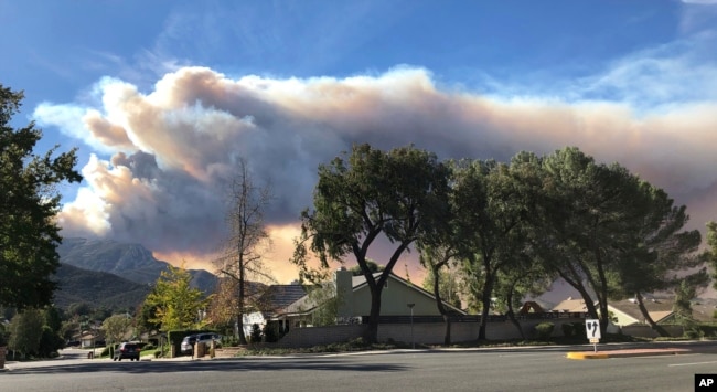 A large wildfire plume from a recent flareup near Lake Sherwood, California, is visible from Thousand Oaks, California, Nov. 13, 2018.