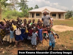Kwame Alexander and children at the library and health clinic in Ghana, 2018