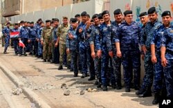 Policemen and soldiers wait to cast their ballots in early voting for Iraq's security forces, ahead of Saturday's national parliamentary elections, in Baghdad, Iraq, May 10, 2018.
