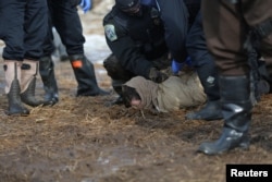 Police detain a man in an attempt to clear the Oceti Sakowin camp in Cannon Ball, North Dakota, U.S., February 23, 2017.