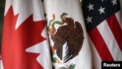 Flags are pictured during the fifth round of NAFTA talks involving the United States, Mexico and Canada, in Mexico City, Nov. 19, 2017. 