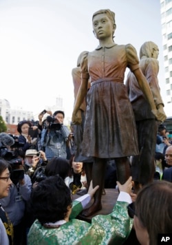 Former World War II "comfort woman" Yongsoo Lee, 89, of South Korea, walks around the "Comfort Women" monument after it was unveiled, Sept. 22, 2017, in San Francisco. The monument was dedicated to the young women victims of Japanese military sexual slavery.