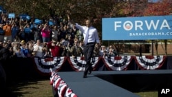 President Barack Obama arrives to speak at a campaign event at Veteran's Memorial Park in Manchester, New Hampshire, Oct. 18, 2012.