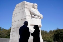 FILE - President Joe Biden and Vice President Kamala Harris stand together at the Martin Luther King, Jr. Memorial as they arrive to attend an event marking the 10th anniversary of the dedication of memorial in Washington, Oct. 21, 2021.