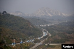 Buses transporting South Korean participants for a reunion travel on the road leading to North Korea's Mount Kumgang resort, in the demilitarized zone (DMZ) separating the two Koreas, just south of the DMZ in Goseong, South Korea, Oct. 20, 2015.