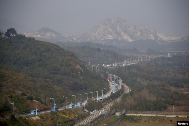 FILE - Buses transporting South Korean participants for a reunion travel on the road leading to North Korea's Mount Kumgang resort, in the demilitarized zone (DMZ) separating the two Koreas, just south of the DMZ in Goseong, South Korea, Oct. 20, 2015.