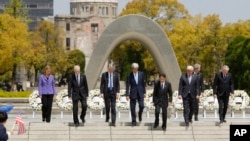 G7 foreign ministers, from left to right, E.U. High Representative for Foreign Affairs Federica Mogherini, Canada's Foreign Minister Stephane Dion, Britain's Foreign Minister Philip Hammond, U.S. Secretary of State John Kerry, Japan's Foreign Minister Fumio Kishida, Germany's Foreign Minister Frank-Walter Steinmeier, Italy's Foreign Minister Paolo Gentiloni and France's Foreign Minister Jean-Marc Ayrault walk together after placing wreaths at the cenotaph at Hiroshima Peace Memorial Park in Hiroshima, western Japan, Monday, April 11, 2016. (Jonathan Ernst/Pool Photo via AP)
