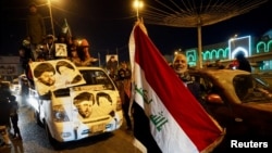 Iraqi supporters of Muqtada al-Sadr's movement celebrate after Iraq's Supreme Court ratified the results of parliamentary election, in Najaf, Iraq, Dec. 27, 2021.