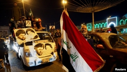 Iraqi supporters of Muqtada al-Sadr's movement celebrate after Iraq's Supreme Court ratified the results of parliamentary election, in Najaf, Iraq, Dec. 27, 2021.
