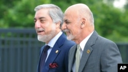 FILE - Afghanistan's President Ashraf Ghani, right, and Chief Executive Abdullah Abdullah arrive for sessions of the second day of the NATO Summit, in Warsaw, Poland, Saturday, July 9, 2016.