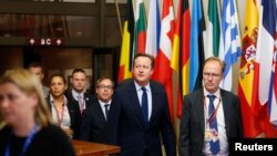 FILE - The U.K. ambassador to the European Union Ivan Rogers, right, walks with then-Prime Minister David Cameron as they leave the EU Summit in Brussels, Belgium, June 28, 2016.