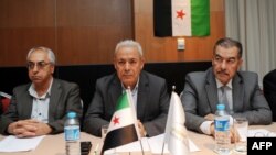 Leaders of the exiled Syrian National Council (SNC), Muhammet Faruq Tayfur (R), Burhan Ghalioun (C) and Abdel Basset Sayda (L), wait before the start of a meeting in Istanbul to pick a new leader after the resignation of Ghalioun last month to avert divis