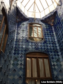 A large skylight illuminates the dark blue tiles of the upper floor of Casa Batllo, in Barcelona.