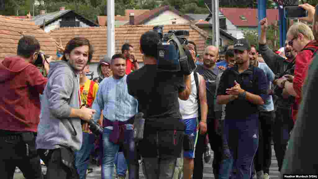 Refugees said they hope the large media presence at this border will encourage authorities to let them pass on their way to Western Europe, at Harmica, Croatia, Sept. 20, 2015.