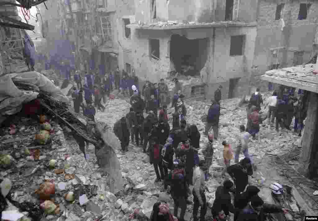 Residents look for survivors after what activists said was an airstrike by forces loyal to Syria&#39;s President Bashar al-Assad in Aleppo, Dec. 15, 2013. 