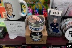 A display of President-elect Joe Biden and Jill Biden books and keepsakes including a scented candle, are available at Browseabout Books, Friday, Nov. 13, 2020, in Rehoboth Beach, Del. (AP Photo/Alex Brandon)