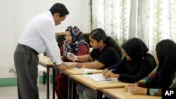 Presidential candidate Yaamin Abdul Gayoom, a brother of 30-year autocratic ruler Maumoon Abdul Gayoom, gets his finger marked with indelible ink before casting his vote in Male, Maldives, Nov. 16, 2013.