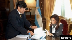 FILE - Argentina's President Cristina Fernandez talks to Legal and Technical Secretary Carlos Zannini at the presidential palace in Buenos Aires, May 29, 2008.