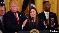 Sarah Sanders and Donald Trump