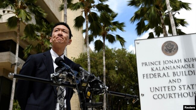 Hawaii Attorney General Douglas Chin answers questions from the media at the U.S. District Court Ninth Circuit after presenting his arguments after filing an amended lawsuit against President Donald Trump's new travel ban in Honolulu, Hawaii, March 15, 20