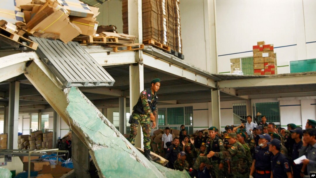 Cambodian rescuers work at the site of a factory collapse in Kai Ruong village, south of Phnom Penh, Cambodia, May 16, 2013.