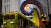 Workers on a platform install flowers on a display in a shape of a train to promoting the upcoming Belt and Road Forum in Beijing, China, April 23, 2019.