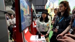 Visitors to the Pax East conference play the new Nintendo Switch video game Animal Crossing, Thursday, Feb. 27, 2020, in Boston. (AP Photo/Steven Senne)