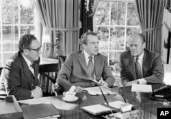 Then-vice presidential nominee Gerald R. Ford (R) listens as President Richard Nixon, accompanied by Secretary of State Henry Kissinger, speaks in the Oval Office of the White House in Washington, Oct. 13, 1973.