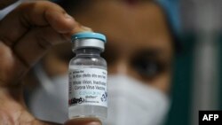 A health staff shows a vial of 'India's first indigenous Covid-19 vaccine, "Covaxin" at the Kolkata Medical College and Hospital in Kolkata on February 3, 2021. (Photo by DIBYANGSHU SARKAR / AFP)