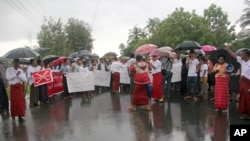 Hundreds of demonstrators hold banners and shout slogans in protest against the arrival of former United Nations secretary-general Kofi Annan, outside of the airport in Sittwe, Rakhine State, Myanmar, Sept. 6, 2016.