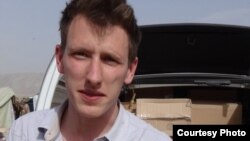 FILE - Abdul-Rahman (Peter) Kassig, an American aid worker, is seen making a food delivery to refugees in Lebanon’s Bekaa Valley, May 2013. (Courtesy of Kassig family)