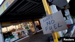 A sign showing customers that fuel has run out is pictured at the Hilltop Garage petrol station, in Rothley, Leicestershire, Britain, Sept. 25, 2021.