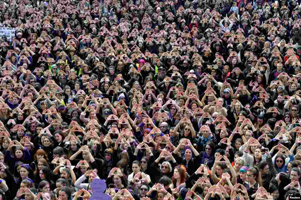 Protesters form triangles with their hands during a demonstration for women&#39;s rights in Bilbao, Spain, on International Women&#39;s Day.
