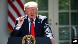 President Donald Trump speaks about the U.S. role in the Paris climate change accord, June 1, 2017, in the Rose Garden of the White House in Washington. 